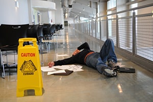 Wet floor sign next to a person on the floor